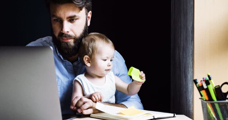 Father with young child and laptop.